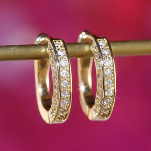 Macro shot of U-shaped gold earrings with double-row micro-pave pavé zircon stones