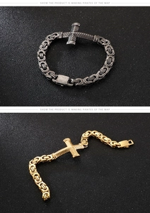 Detail of vintage Byzantine chain bracelets with cross charms in gold and black silver