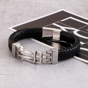 Men's braided leather bracelet with stainless steel magnetic clasp on stone background