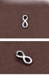Macro shot of mirror-polished stainless steel infinity symbol charm for DIY jewelry