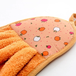 Detail of hanging coral fleece hand towel with orange absorbent fibers and fruit pattern