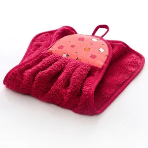 Detail of red dress-shaped hanging towel in coral fleece with apple pattern print