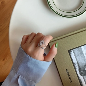 Detailed view of 925 silver crown ring with pear-shaped zircon on an elegant book