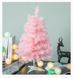 Mini pink PVC Christmas tree on white base with festive lights and deer decoration