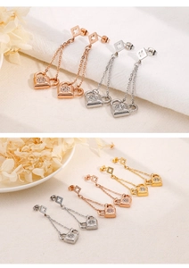 Detail showing titanium steel tassel earrings with crystal lock charms in multi-color sets