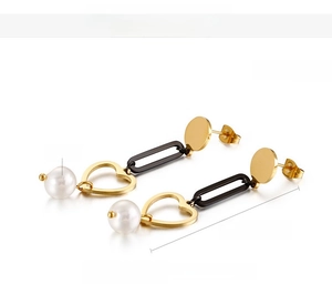 Detailed view of heart-shaped pearl drop earrings with black rectangular link and steel