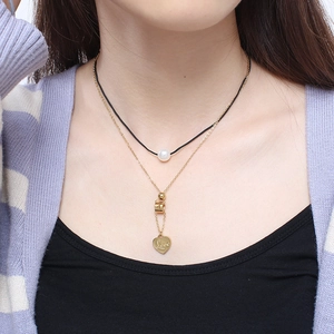 Double-layer necklace featuring a black cord with pearl and a golden heart Love pendant