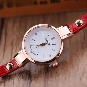 Close-up of a rose gold watch featuring a white dial with rhinestones and red snakeskin strap