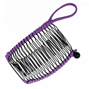 Detail of flexible black wire hair comb with purple elastic bands and round bead closure