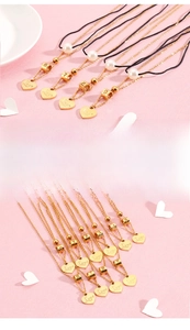 Macro detail of heart-shaped love pendants with numbers 1-9 and white pearl accents