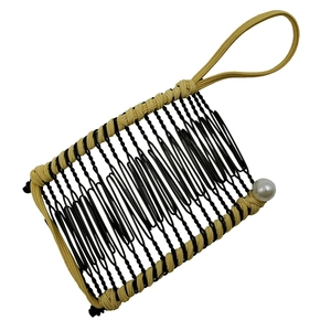 Banana hair clip with black metal coils, beige woven trim and a white pearl accent