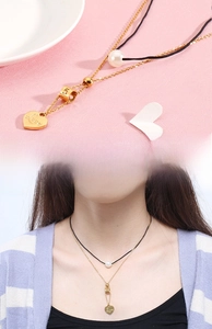 Detail of double-layer necklace with pearl, number 5 bead and heart pendant on model