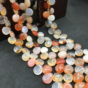 Close-up of heart and teardrop-shaped natural agate beads for DIY jewelry making