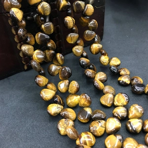 Macro shot of tiger eye stone teardrop beads for DIY jewelry with cat eye effect