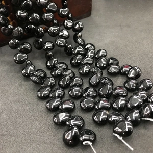 Macro shot of polished black teardrop crystal beads for DIY jewelry and hair accessories