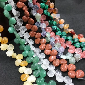 Macro shot of assorted colorful teardrop-shaped natural crystal and agate stone beads
