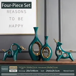 Modern emerald green ceramic bull sculptures and abstract ring vases with gold accents