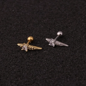 Close-up of wing-shaped stainless steel ear studs with square and round zircons