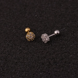 Detailed close-up of gold and silver crown stud earrings with sparkling cubic zirconia