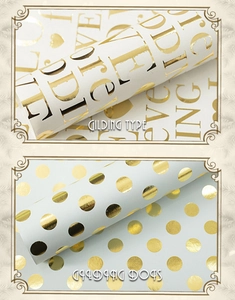 Detail of gold foil polka dot and wedding text patterns on white gift wrapping paper