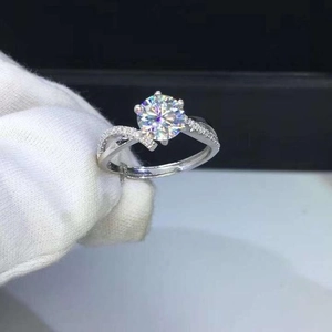 Macro shot of silver stackable engagement rings with round zircon and twisted band