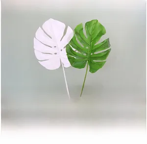Detail of lifelike green and white artificial monstera leaves with realistic textures