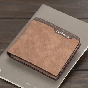 Men's minimalist bifold wallet in khaki and dark brown matte leather on a rustic desk