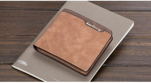 Close-up of brown frosted leather Baellerry men's wallet with stitching on a notebook