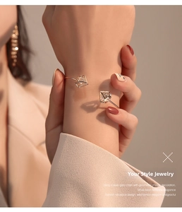 Close-up of rose gold open cuff bracelet with hollow geometric diamond zircon detail