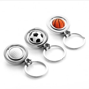 Rotating metal sports ball keychains featuring golf, soccer, and basketball designs