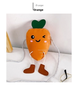 Detail of cute carrot mini crossbody bag with cartoon face and green leaf decoration