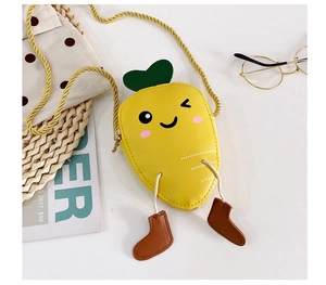 Detailed close-up of a mini carrot crossbody bag in bright yellow with a cute boot charm