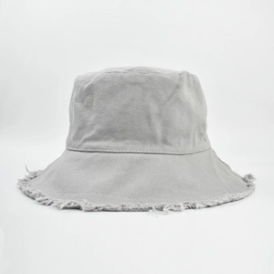 Detail shot of grey bucket hat with distressed frayed edge design and canvas texture
