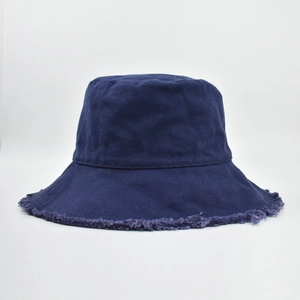 Close-up of navy blue canvas bucket hat with vintage frayed edges and cotton texture