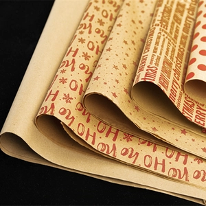 Vintage kraft Christmas wrapping paper roll with Ho Ho Ho and star patterns