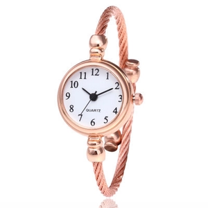 Women's rose gold braided cable bracelet watch with a minimalist white round dial