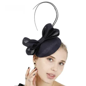 Close-up of navy blue Sinamay fascinator hat with elegant bow and feather details