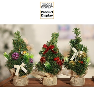 Detailed view of three mini Christmas trees with burlap bases and festive bows