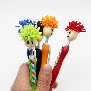Detail of colorful plush mop-head pens featuring cartoon smiley faces and tie-shaped clips