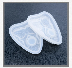 Detail of semi-transparent butterfly resin mold with intricate floral relief textures