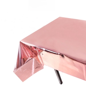 Detail of rose gold foil tablecloth with metallic reflective finish and natural folds