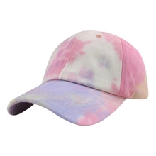 Close-up of pink and purple tie-dye faux fur baseball cap with plush texture