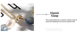 Close-up of golden spring ring clasp with blue aventurine beads and a freshwater pearl