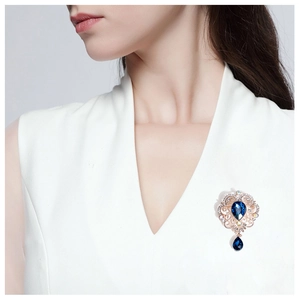 Baroque style teardrop blue crystal brooch pin shown on model for elegant accessory detail