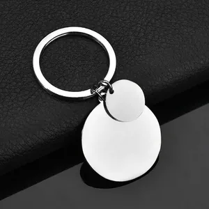 Polished stainless steel double circle keychains on black leather background