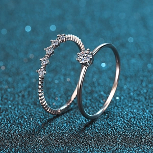 Elegant S925 sterling silver moissanite ring set with round cut stones on blue background