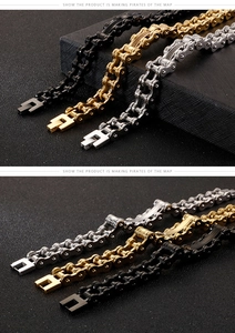 Close-up of dual-row stainless steel motorcycle chain bracelets in black, gold, and silver