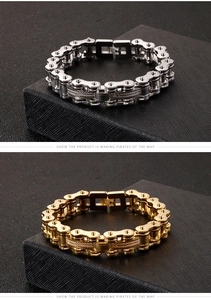 Close-up of heavy-duty stainless steel motorcycle chain bracelet in gold and silver