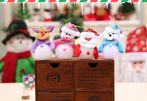 Close-up of lighted EVA Santa and Snowman holiday ornaments on a wooden shelf