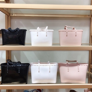 Transparent PVC jelly tote bags with gold pyramid studs in black, white, and pink